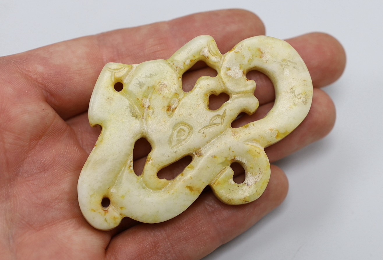 A Chinese pale celadon jade archaistic plaque (huang), a similar plaque and a bowenite jade disc